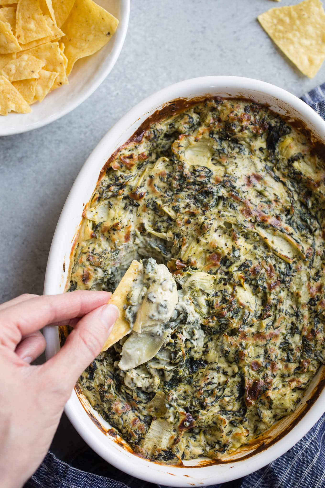 Spinach dip in a white dish.