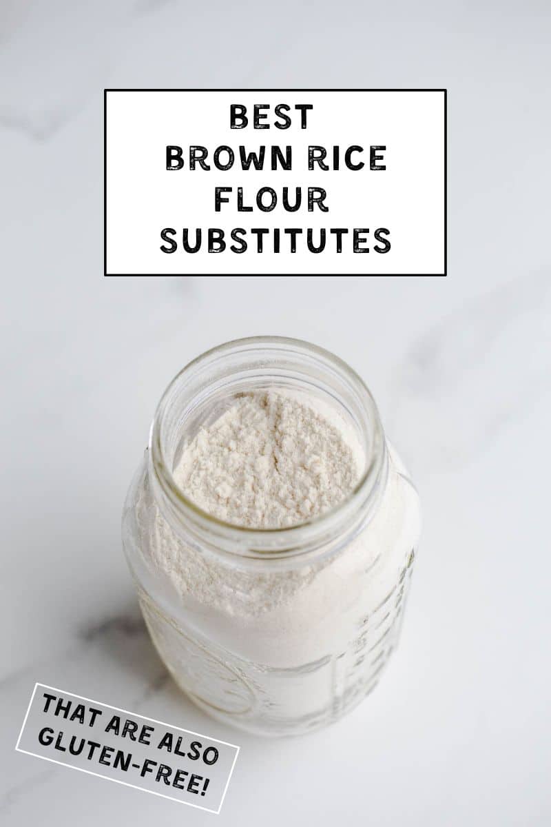 A mason jar filled with flour on a marble surface.