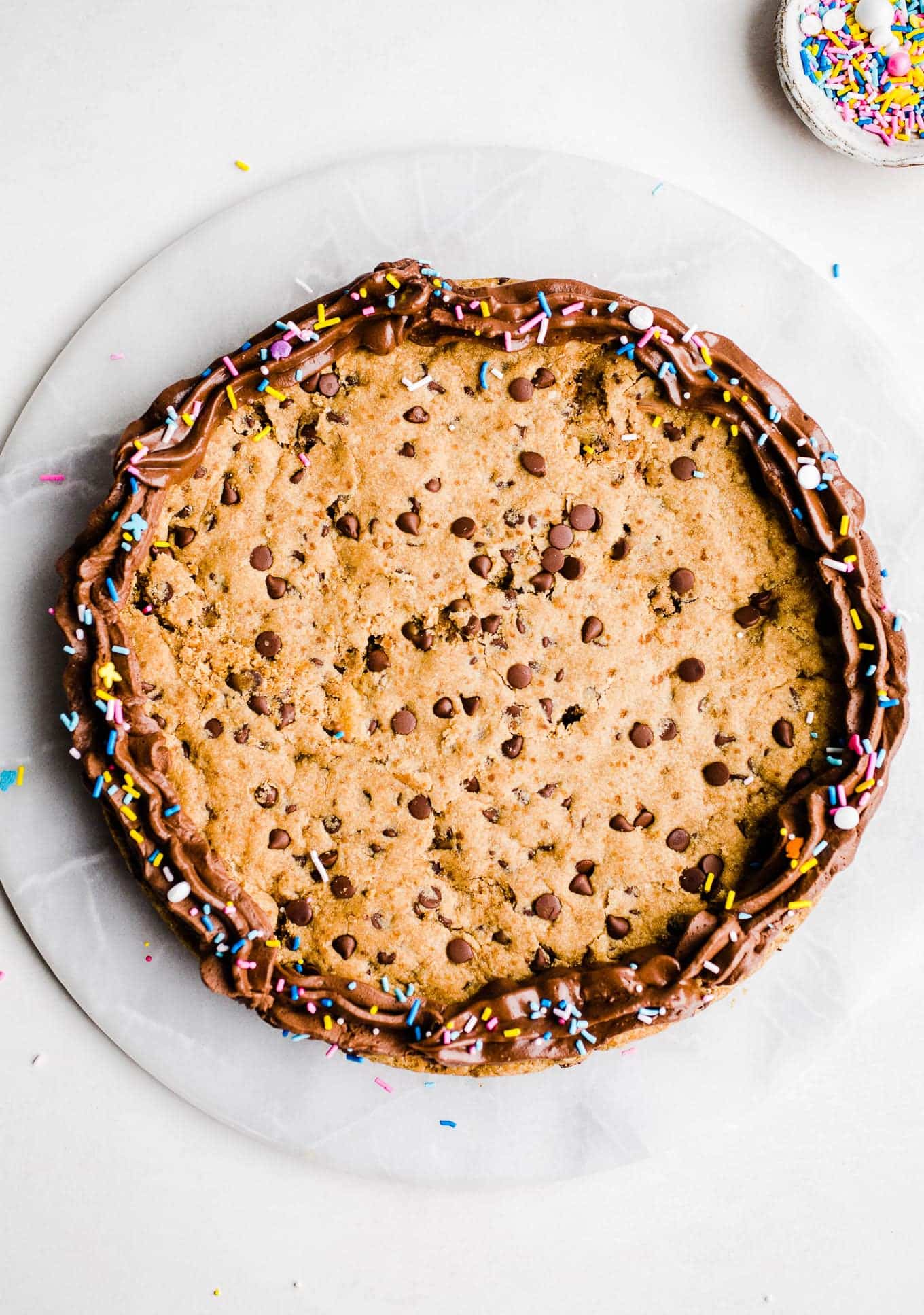 A cookie cake on a marble surface.