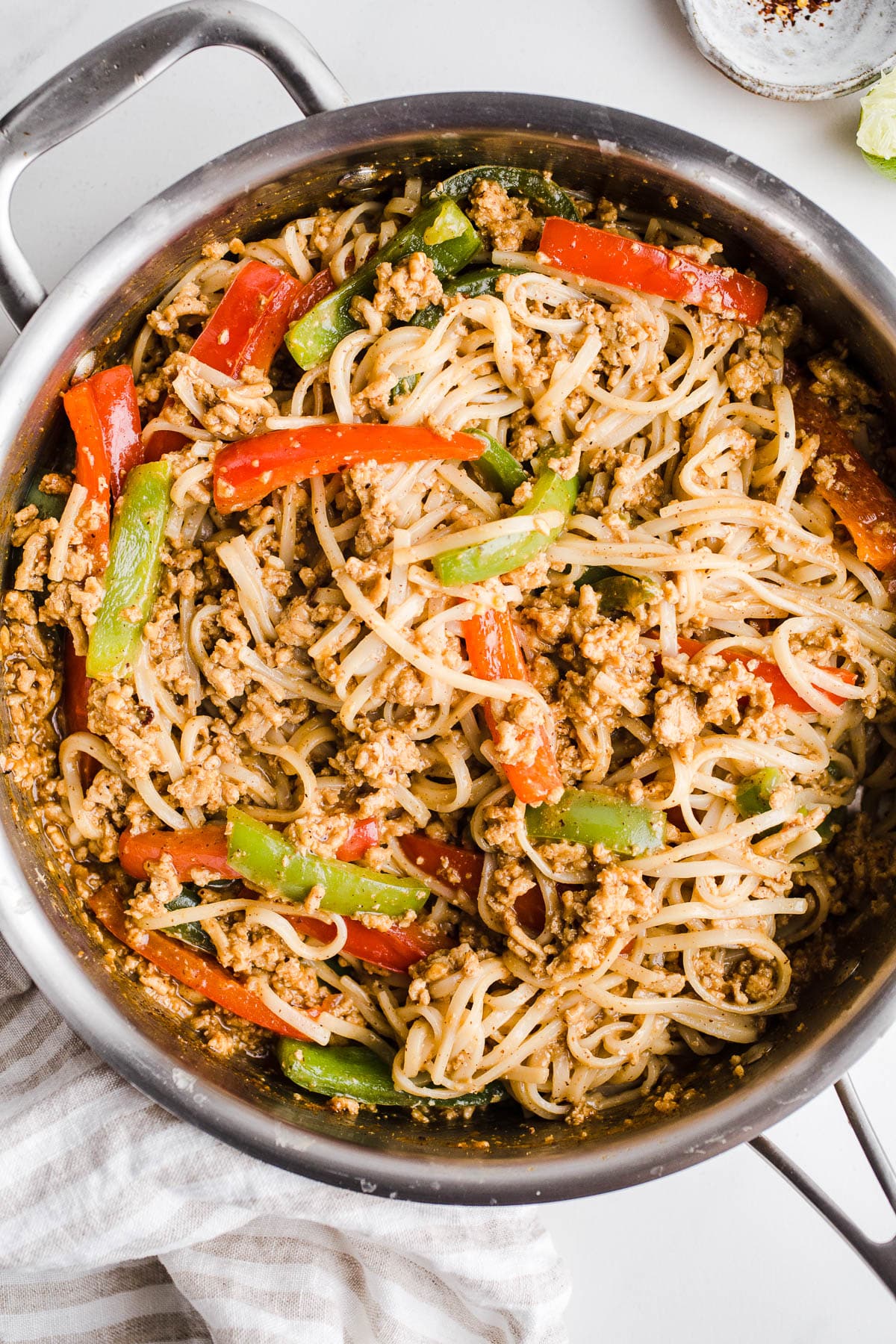 Noodle, meat, and veggies in a large skillet.