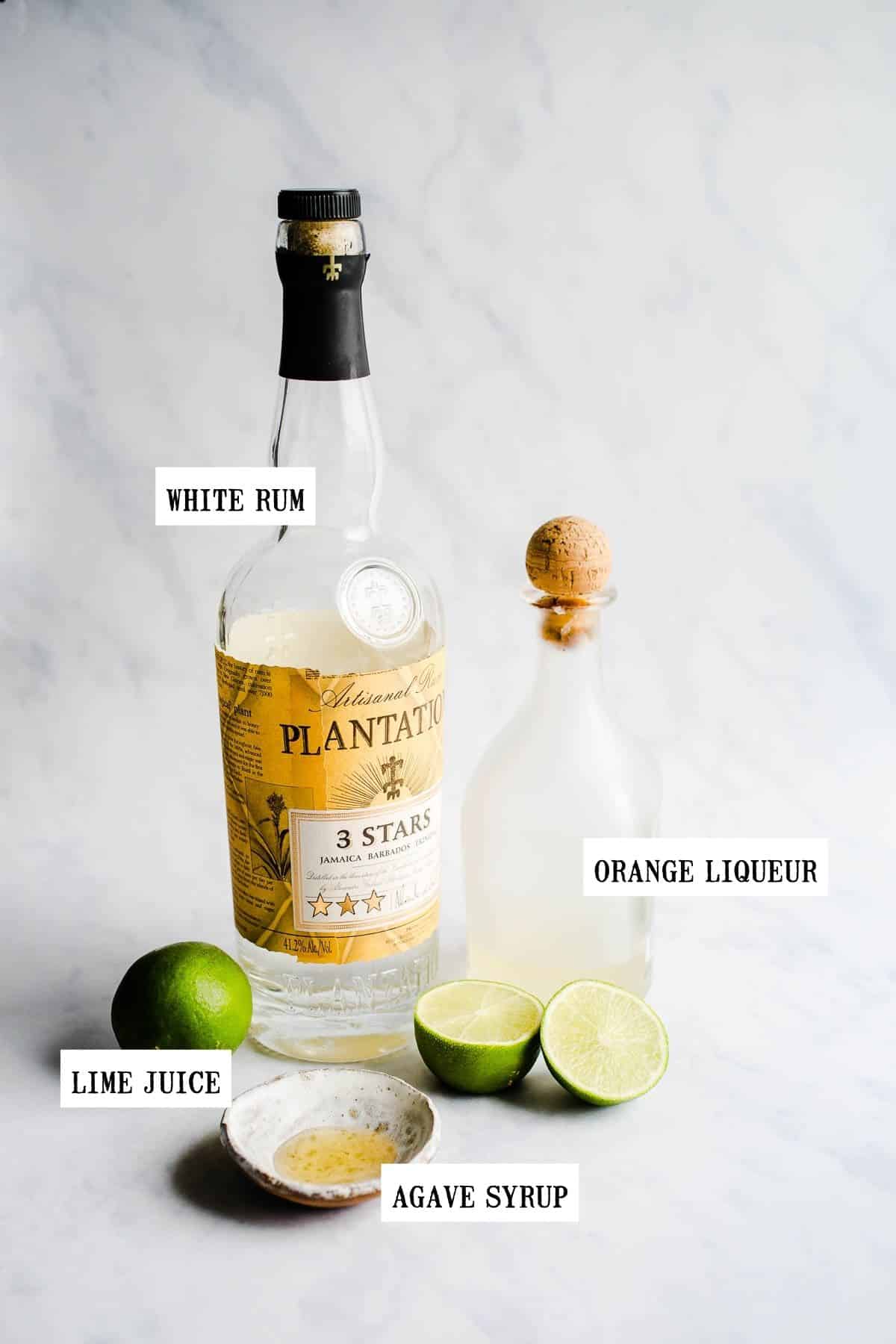 Ingredients to make a margarita on a marble surface.