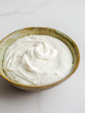 Homemade cream in a green bowl.