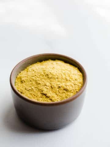 Yellow seasoning in a small gray bowl.
