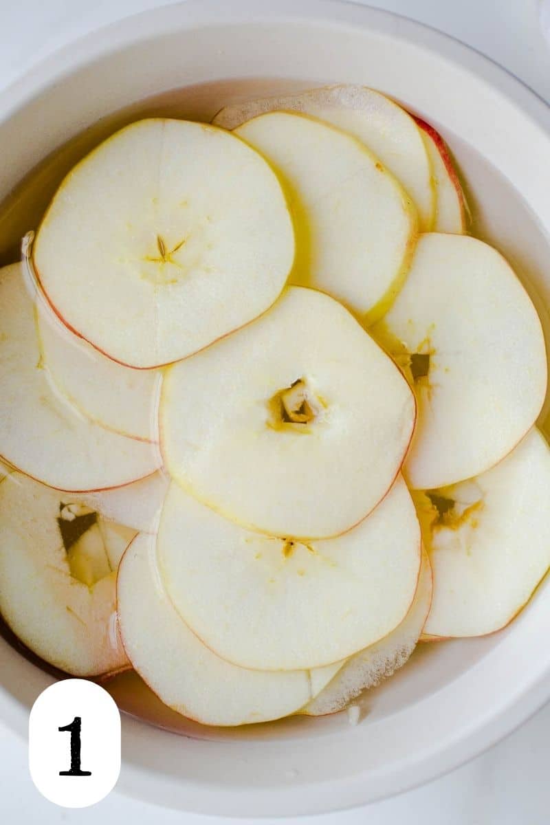 Sliced apples in a bowl of water. 