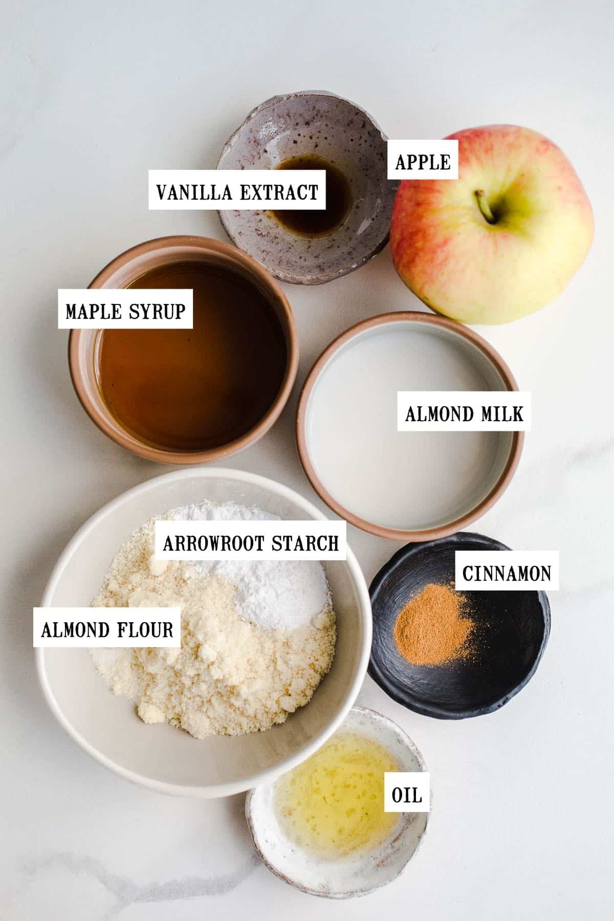 Ingredients to make apple mug cake in small bowls. 