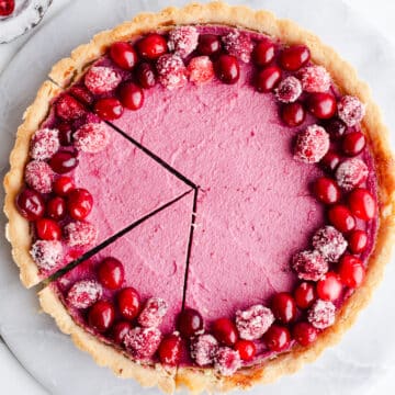 A cranberry tart topped with sugared cranberries.