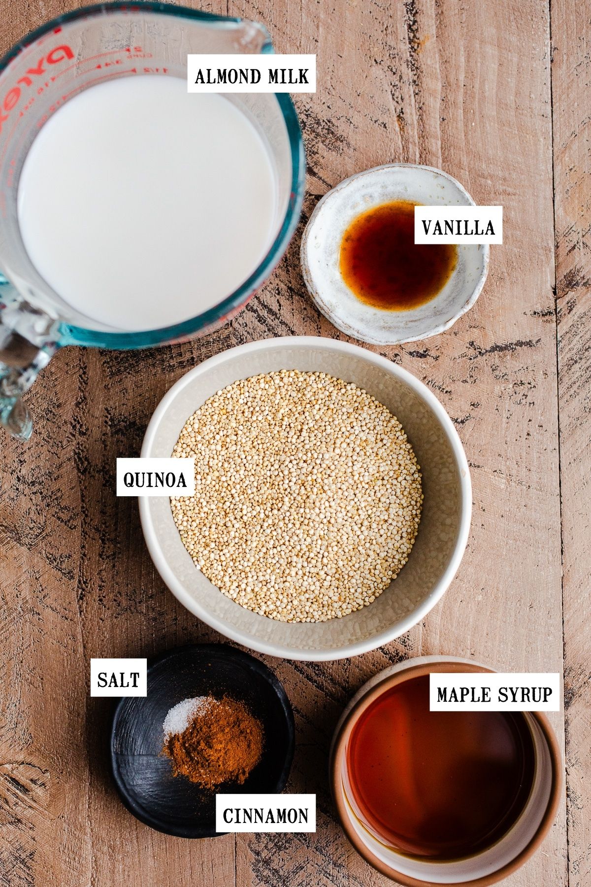 Ingredients to make quinoa porridge in small bowls. 