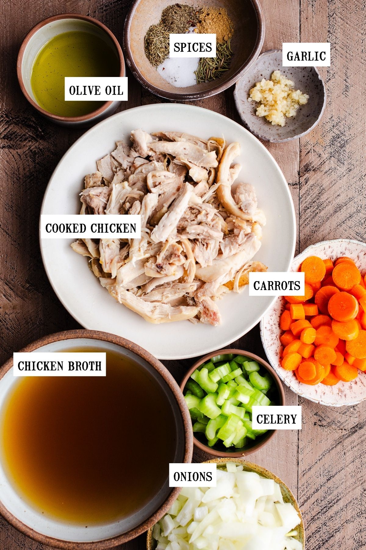 Ingredients to make chicken soup in bowls. 