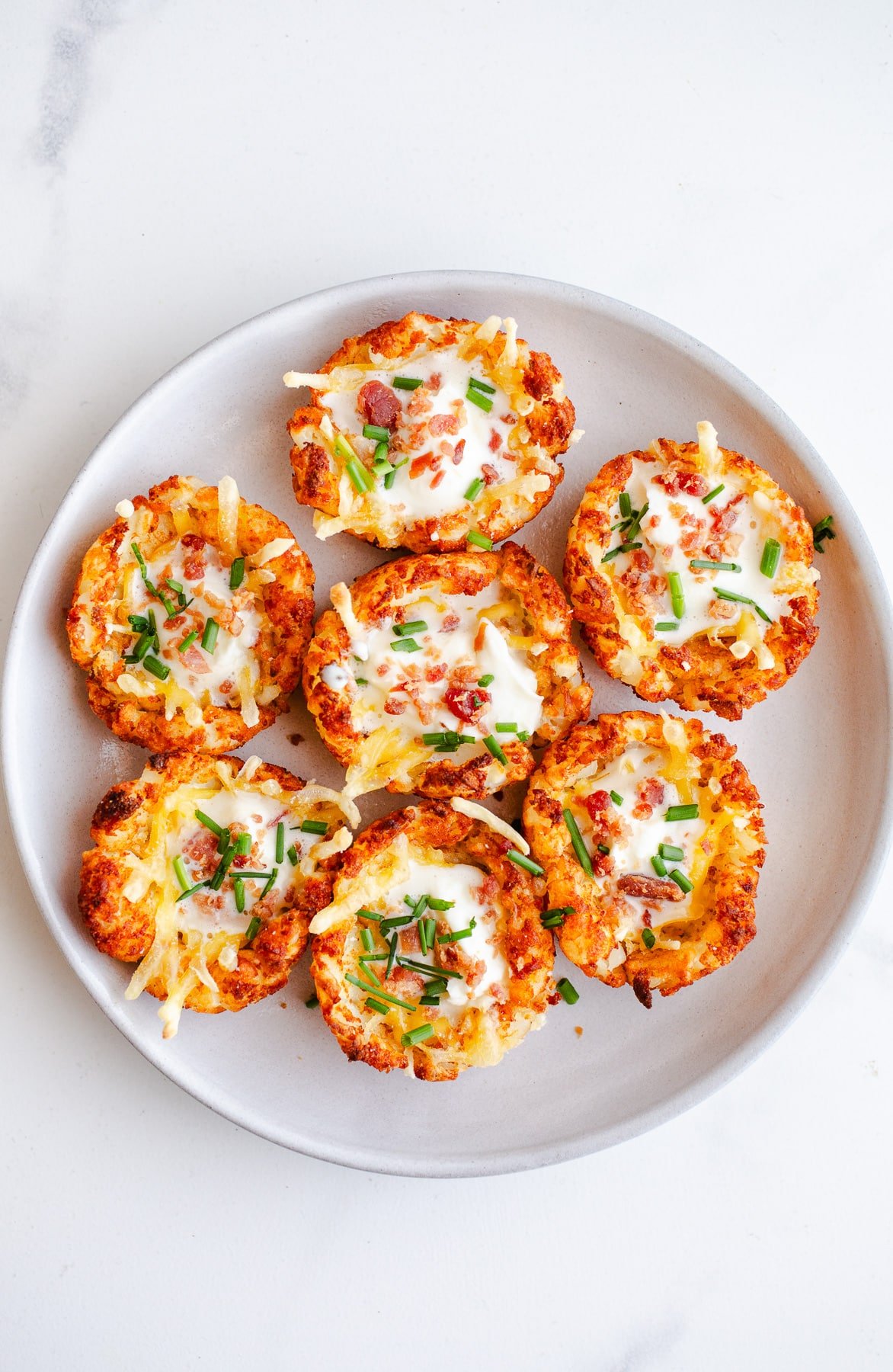 Tater tot cups on a plate. 