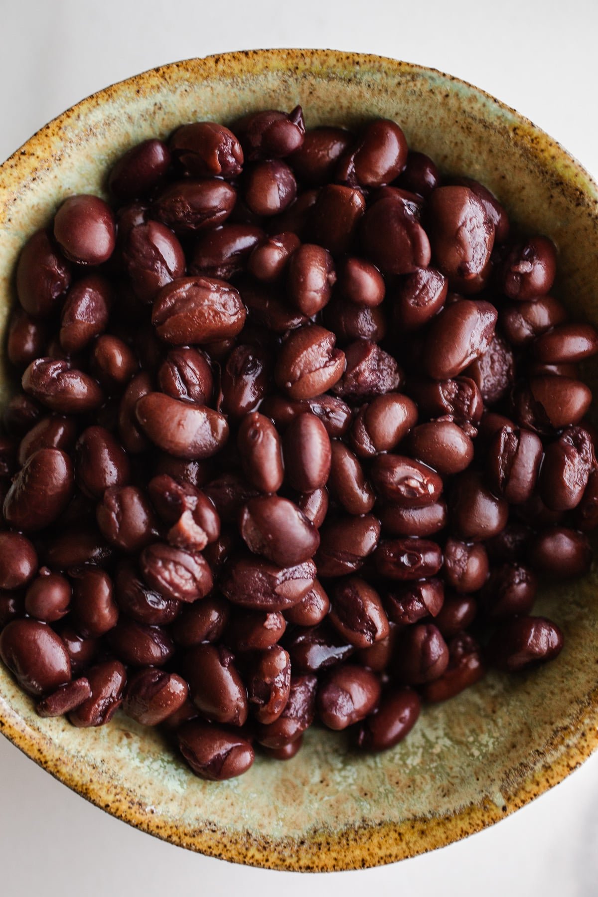 Black beans in a green bowl.