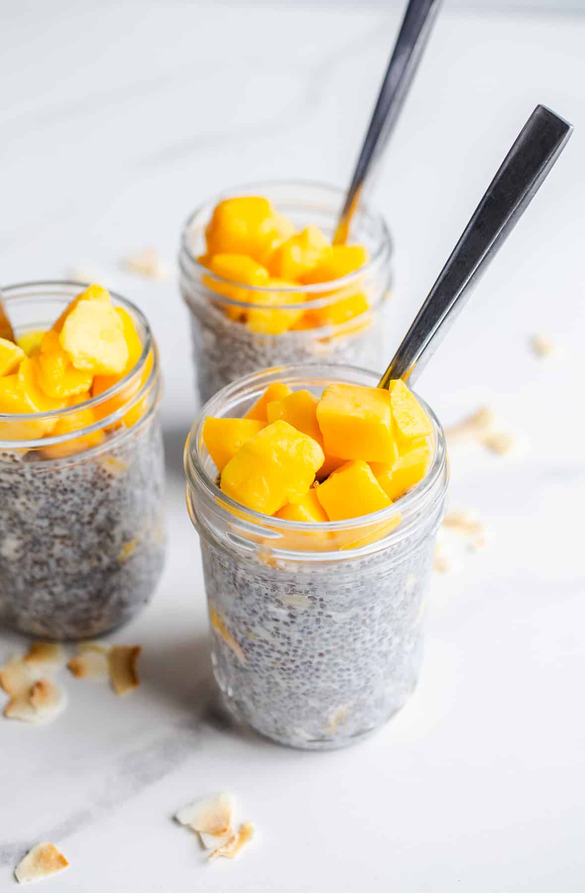 Chia pudding in jars topped with mango.