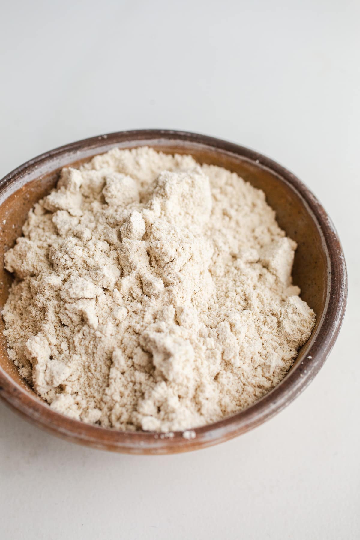 Sorghum flour in a rustic bowl. 