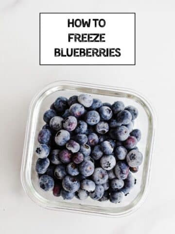 Frozen blueberries in a container.