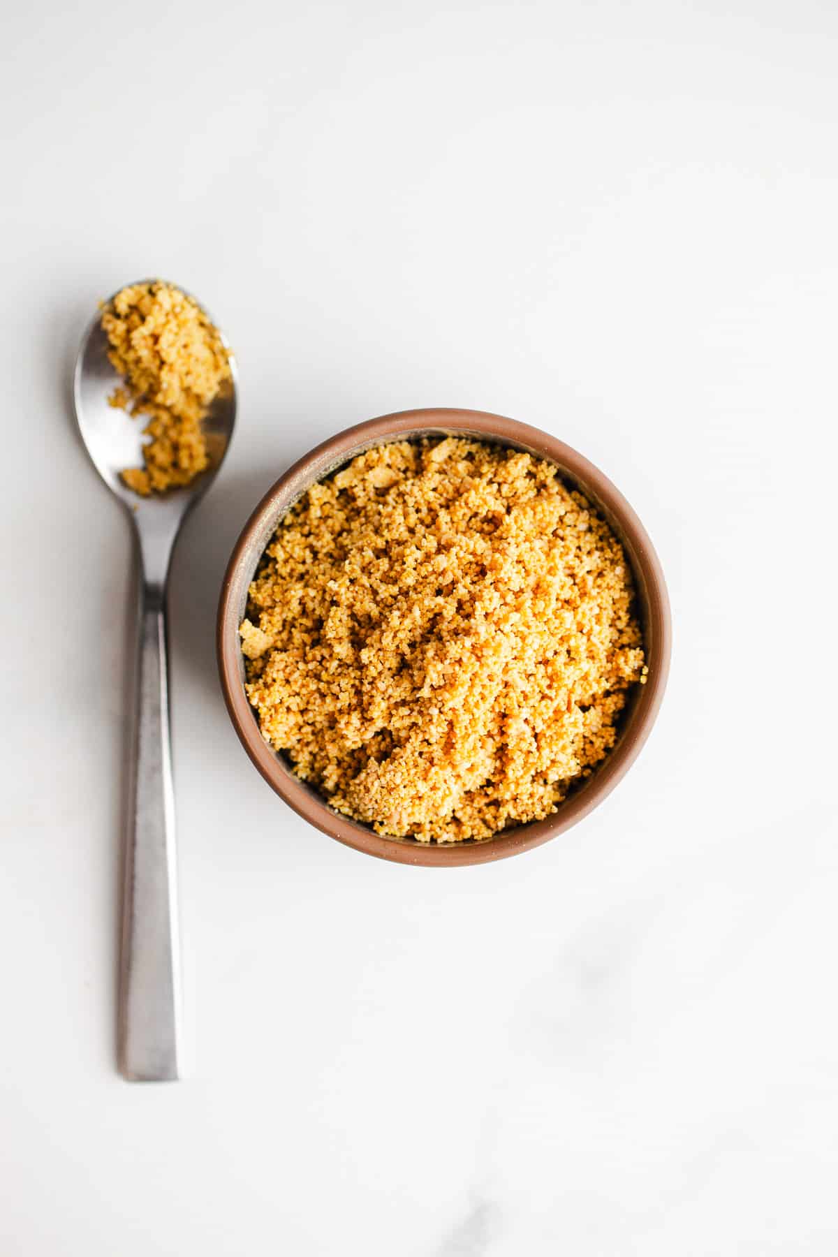 Vegan parmesan cheese topping in a bowl.
