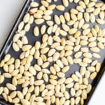 A sheet pan full of blanched almonds.