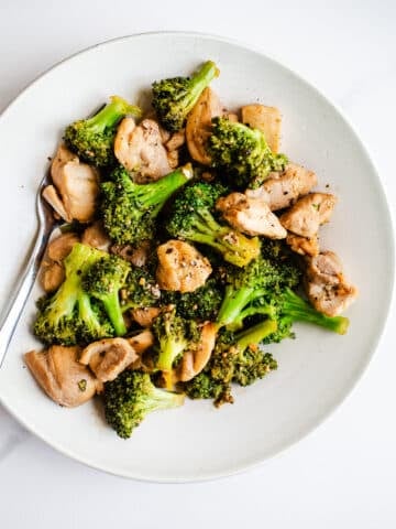 Chicken and broccoli on a white plate.