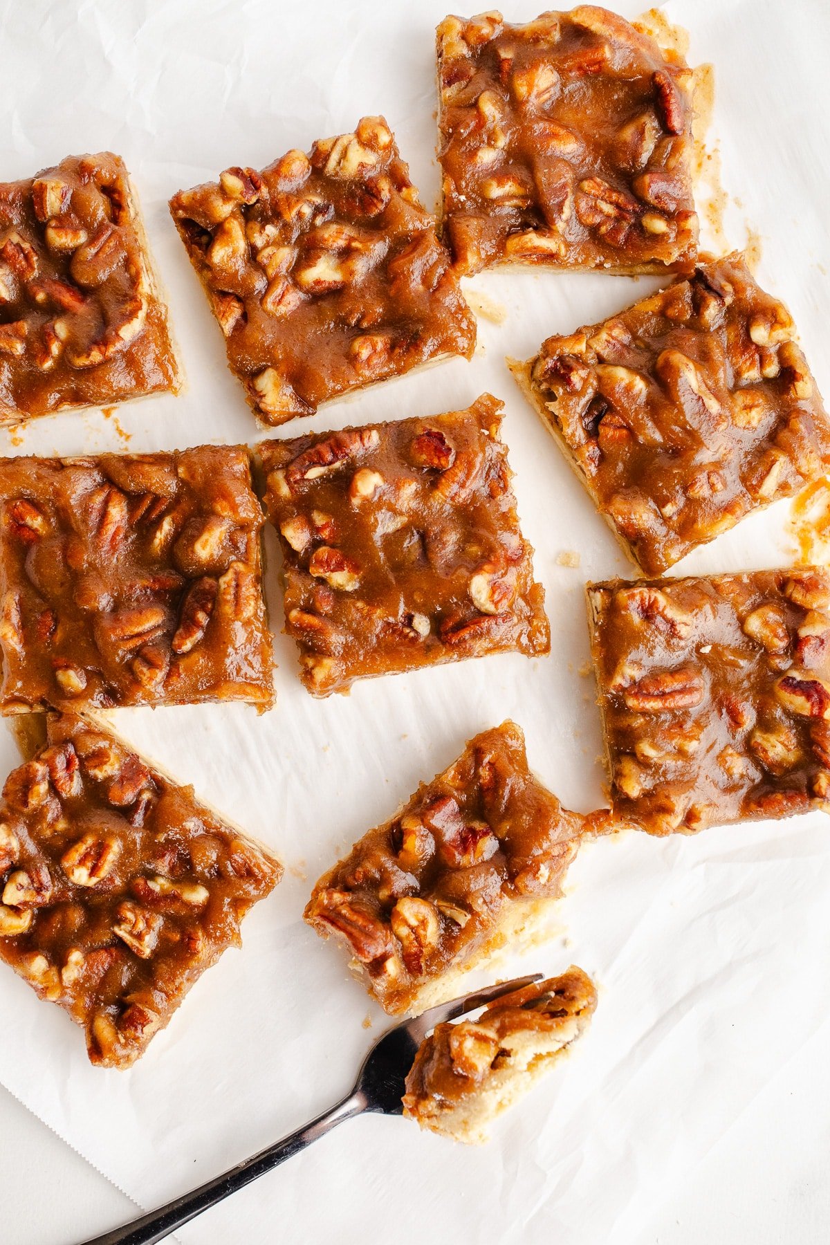 Pecan pie bars on parchment paper.