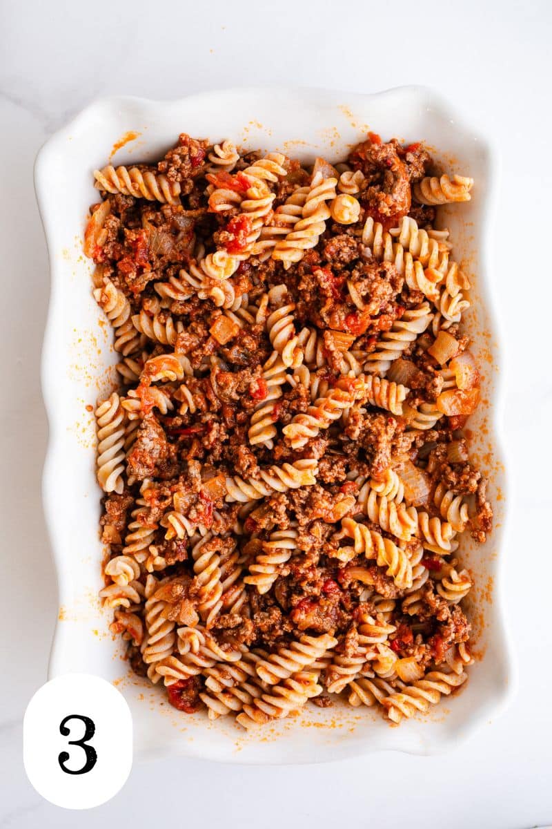 Pasta and sauce in a casserole dish. 