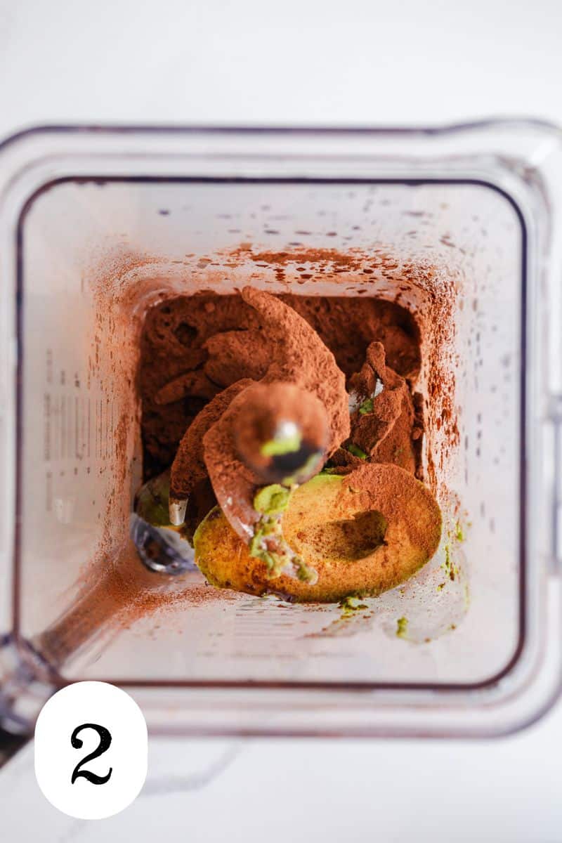 Cocoa powder and avocado in a blender. 