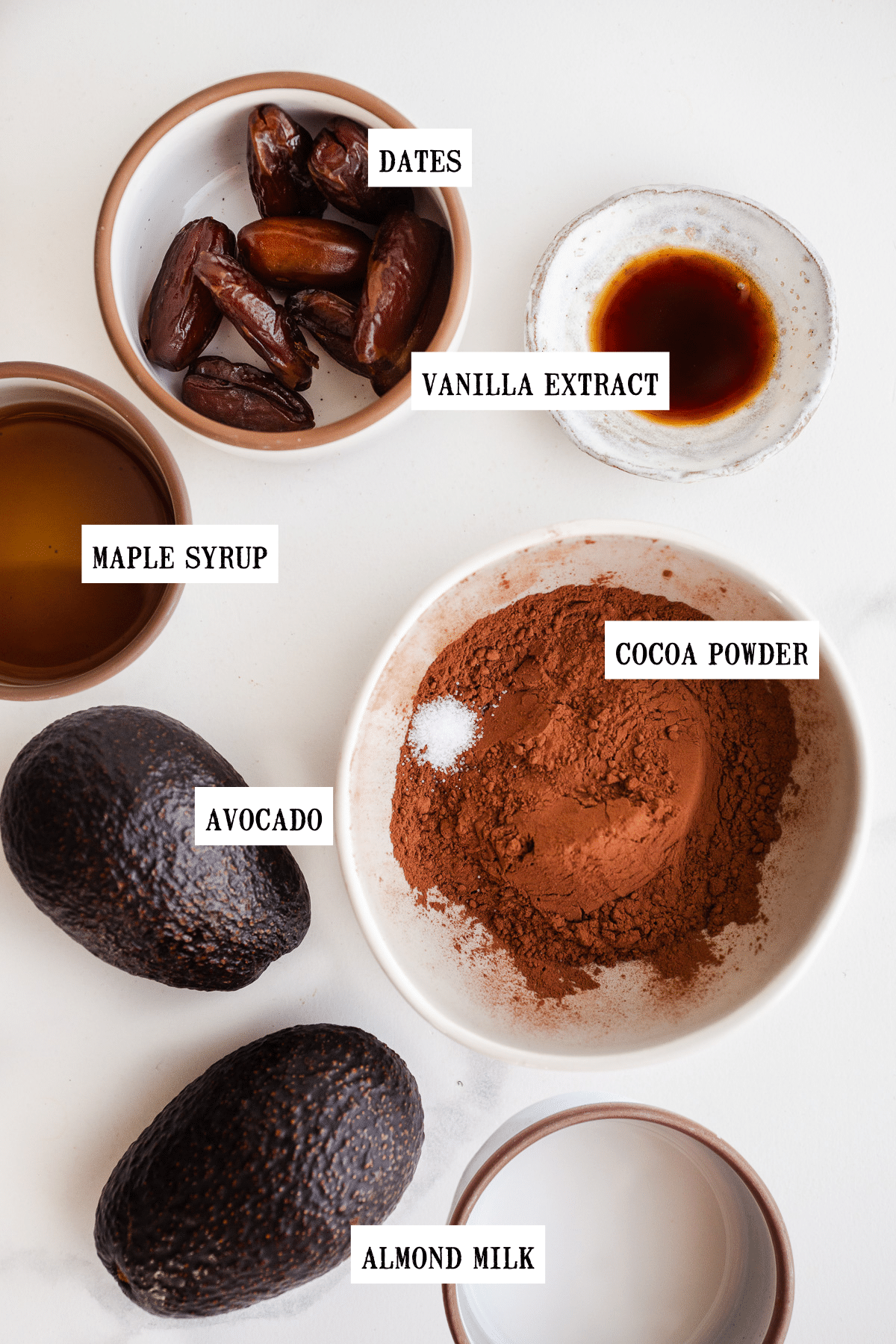 Ingredients to make chocolate mousse in small bowls.