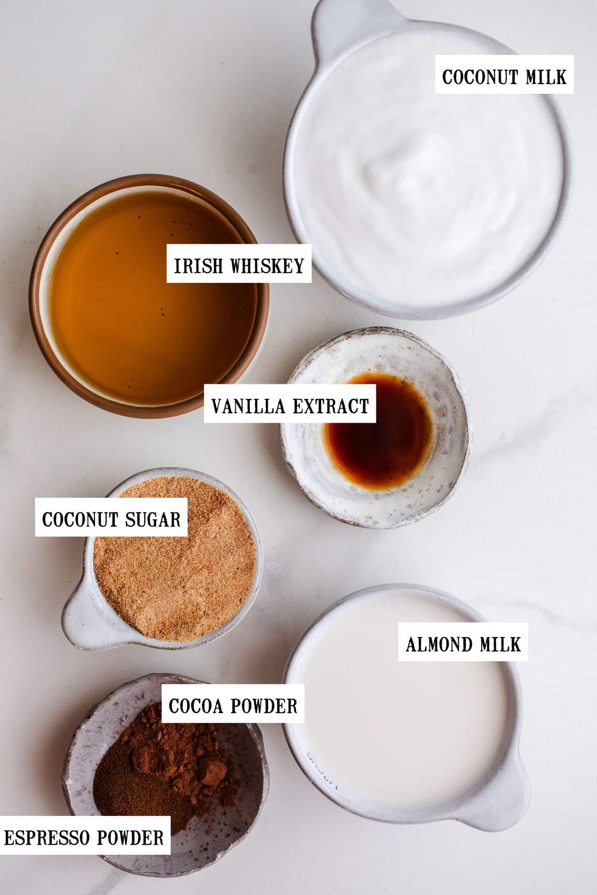 Ingredients to make homemade Baileys in small bowls.