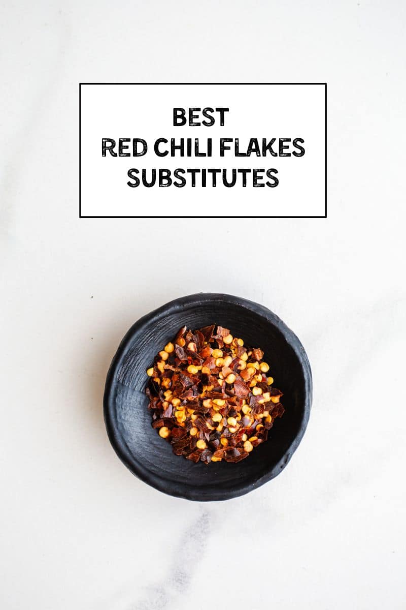 A small bowl filled with red chili flakes. 