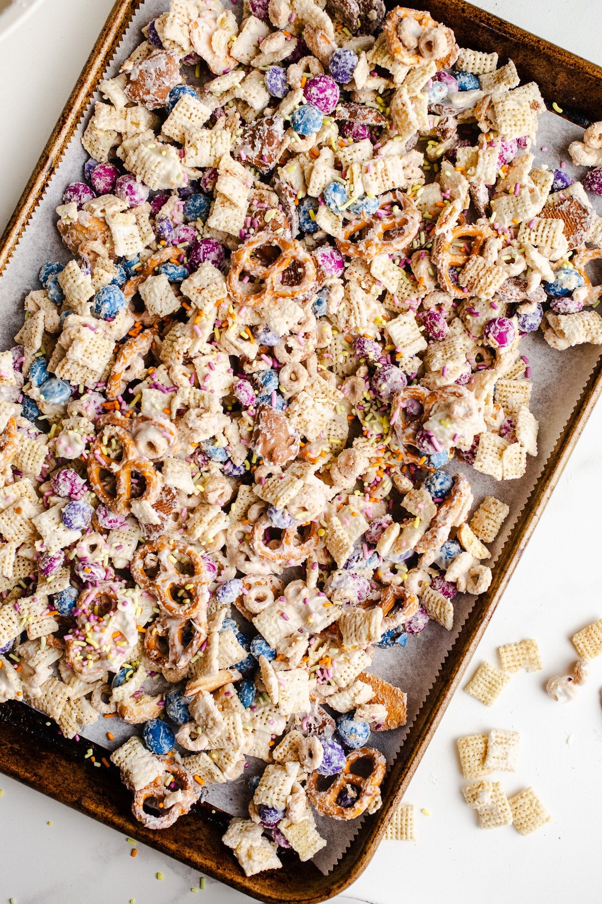 Bunny Bait Chex mix with white chocolate on a sheet pan.