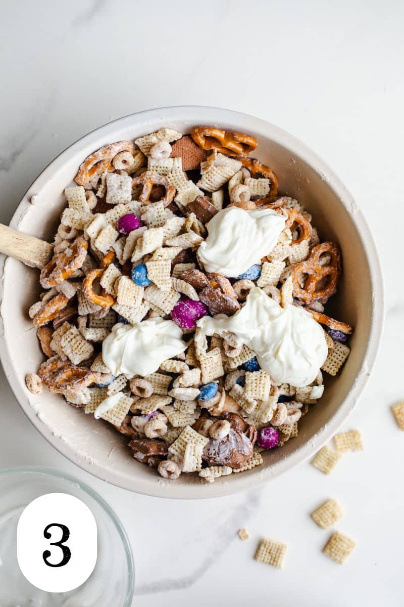 Snack ingredients and white chocolate in a bowl.
