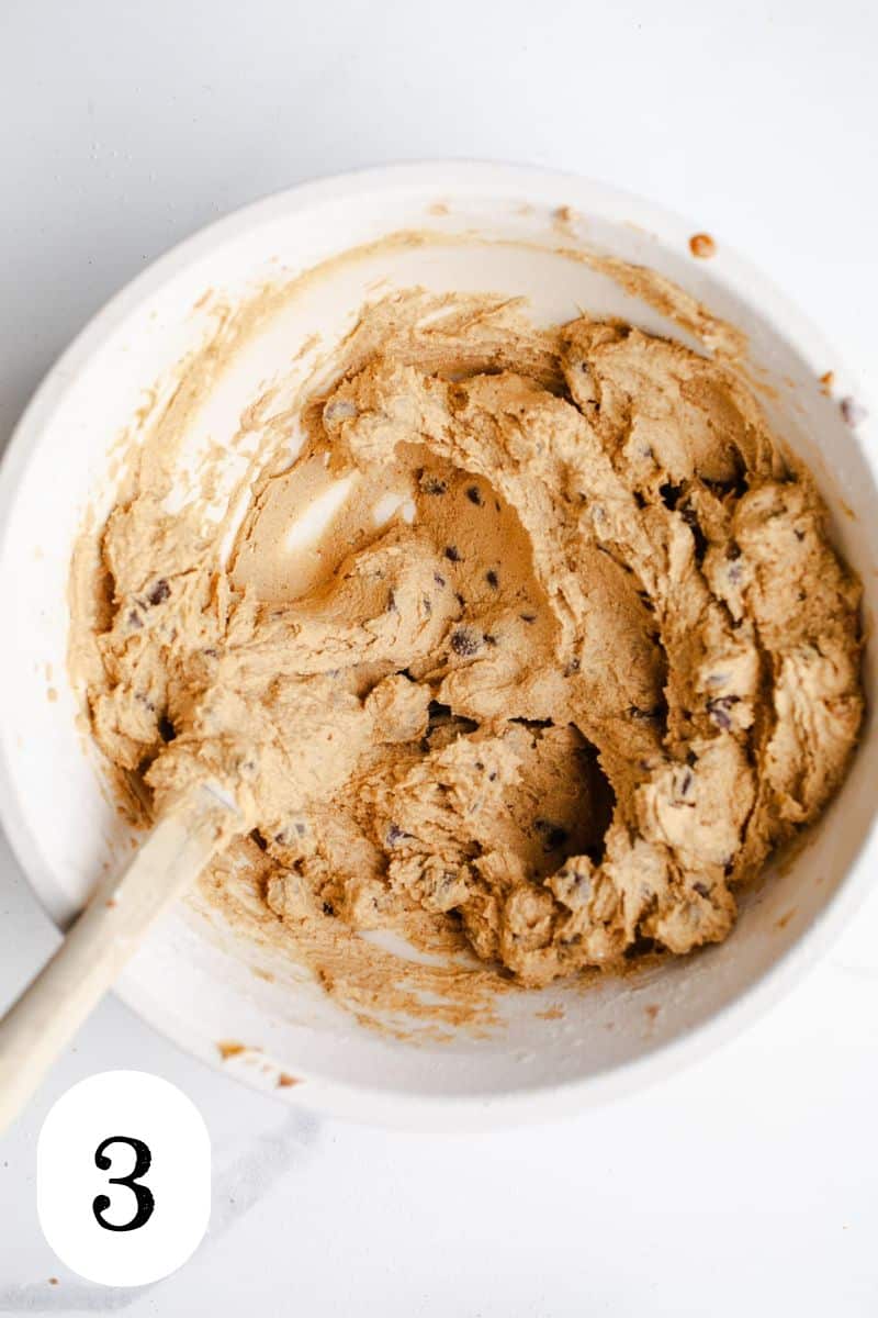 Chocolate chip cookie dough in a mixing bowl. 