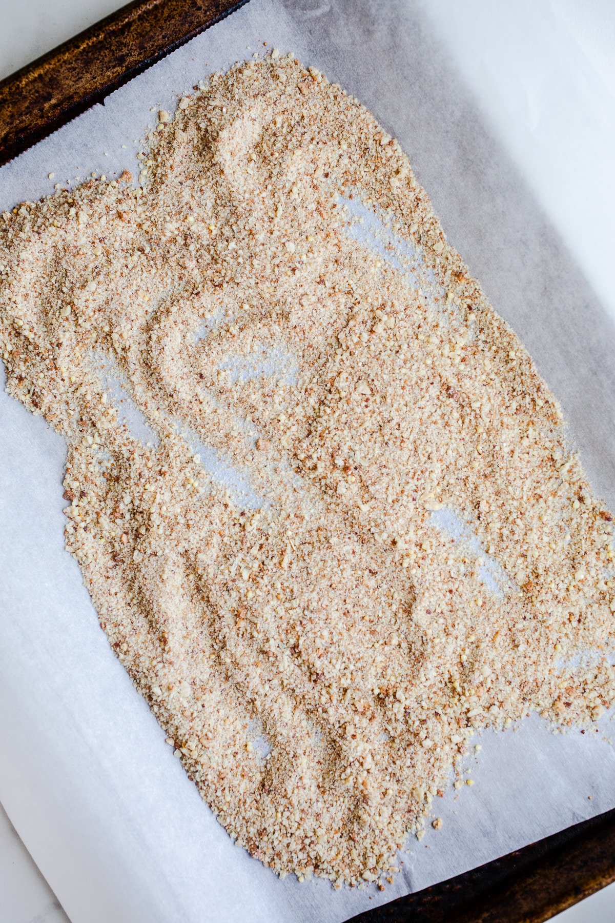 Breadcrumbs on a baking sheet.