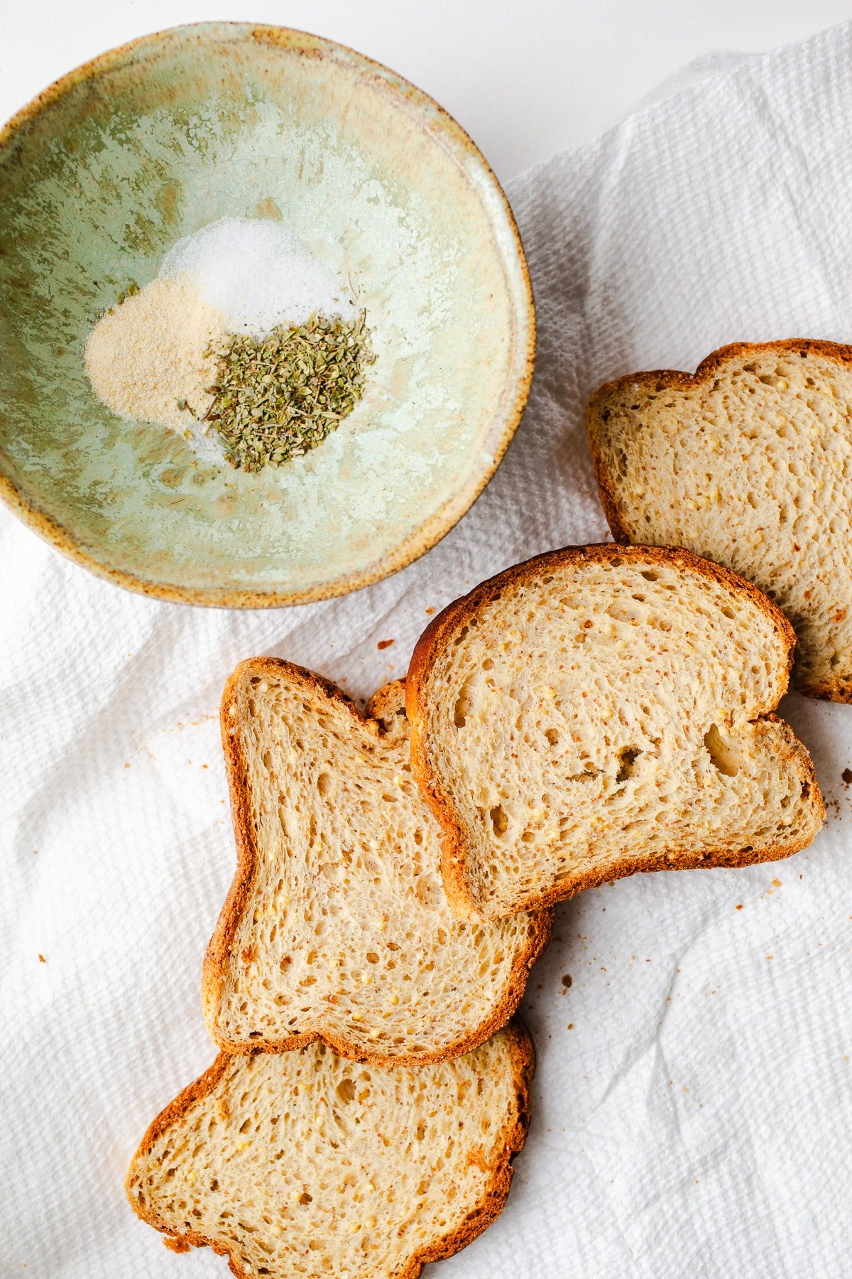 Bread and seasoning on parchment paper.