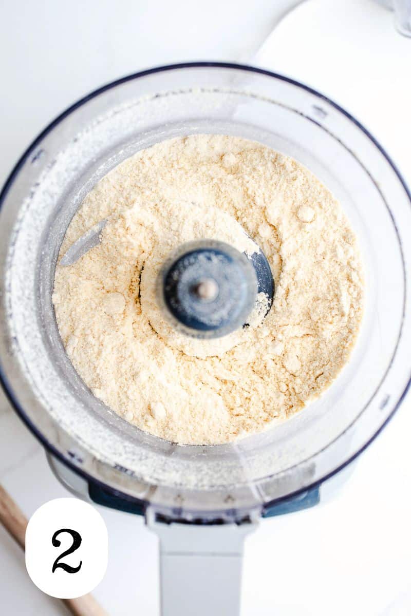 Millet flour in the bowl of a food processor.
