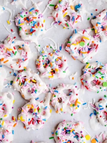 White chocolate pretzels on parchment paper.