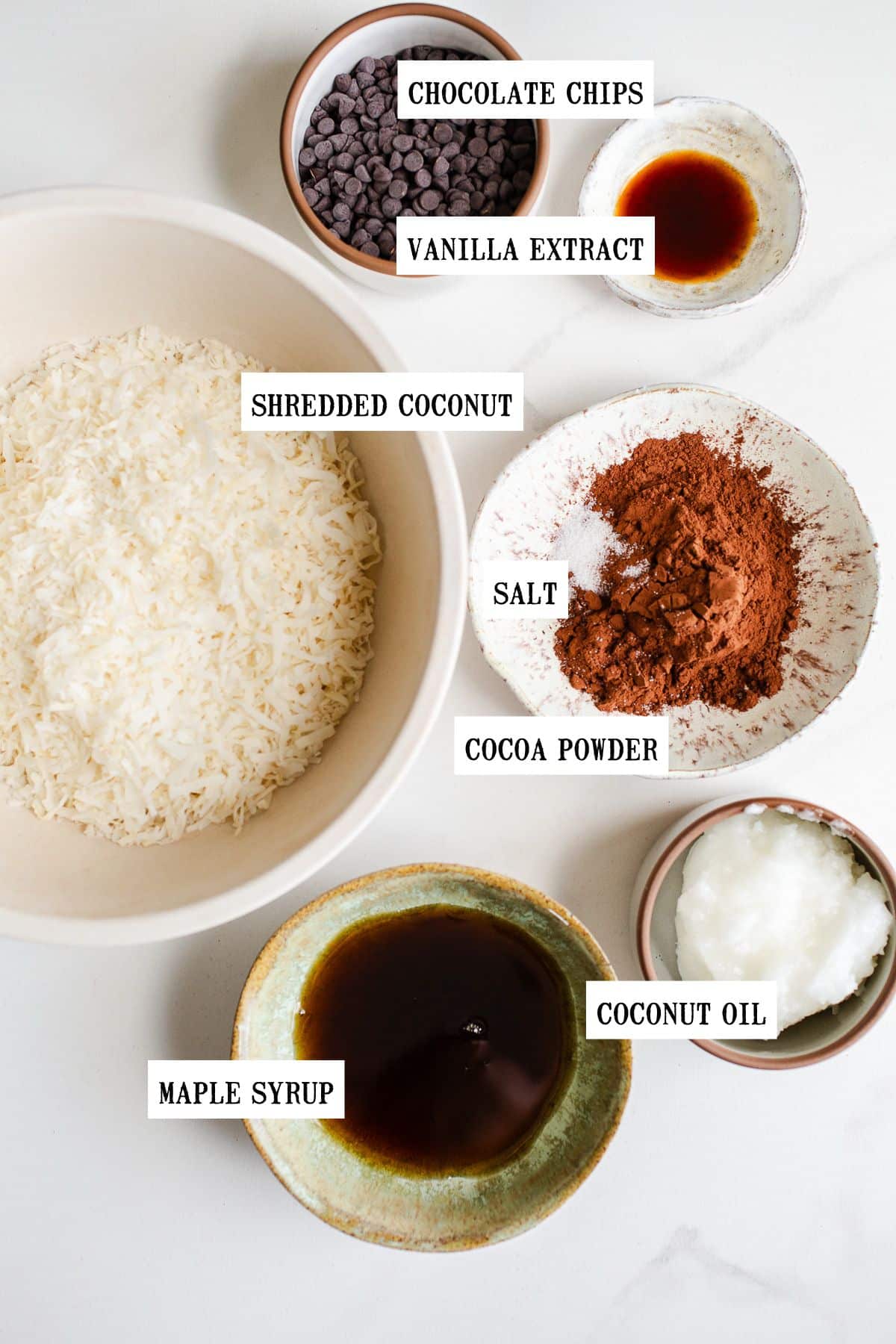 Ingredients to make no bake coconut bars in small bowls. 