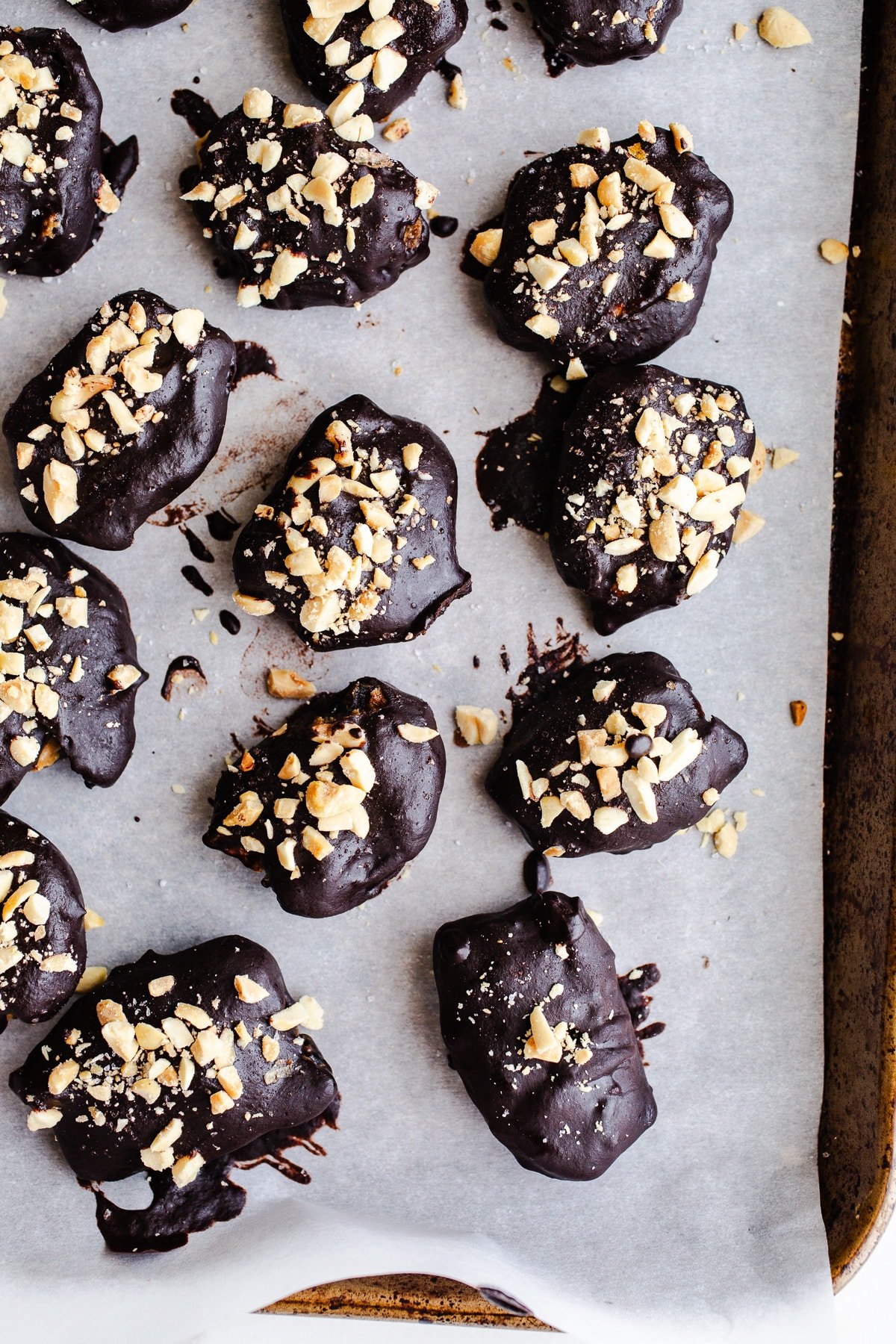 Chocolate-covered date snickers with crushed peanuts. 