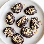 Chocolate-dipped dates on a plate.