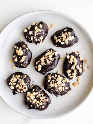 Chocolate-dipped dates on a plate.