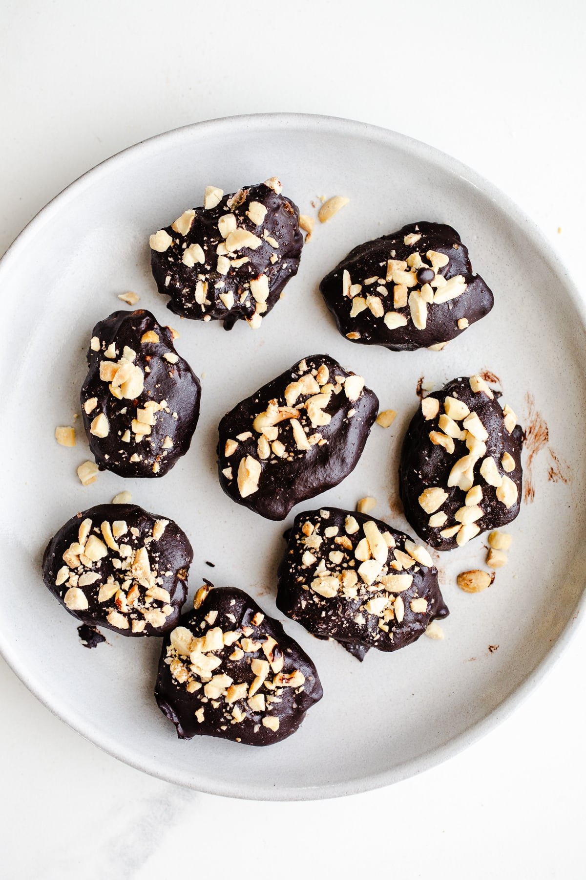 Chocolate-dipped dates on a plate. 