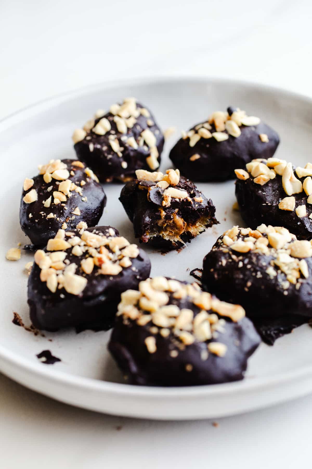 Date Snickers bites on a plate.