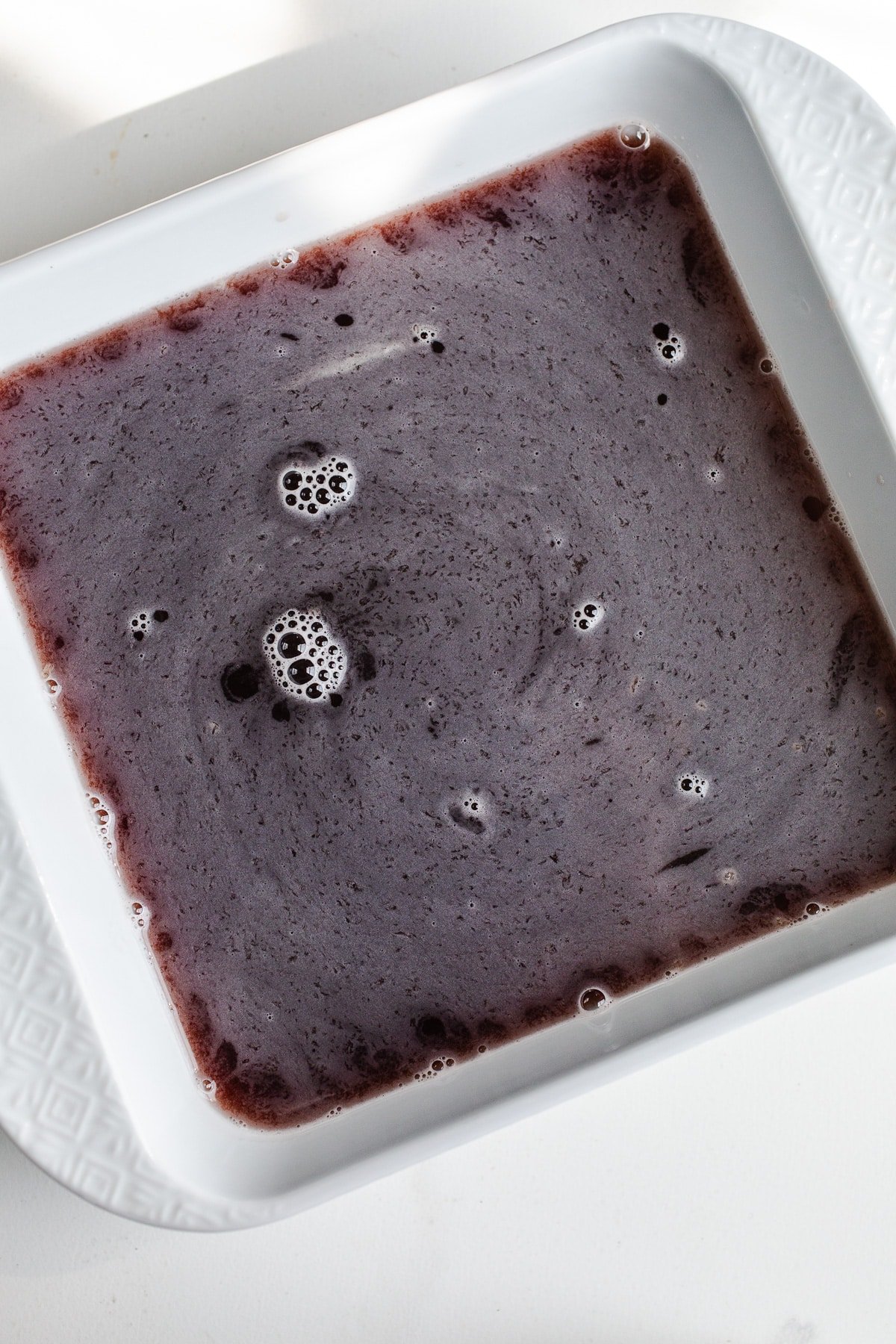 Blueberry mixture in a square baking dish.