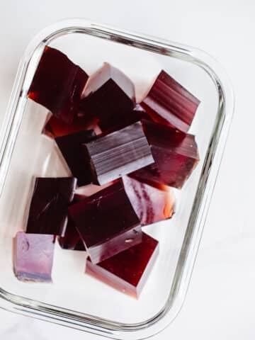 Blueberry gummies in a glass container.