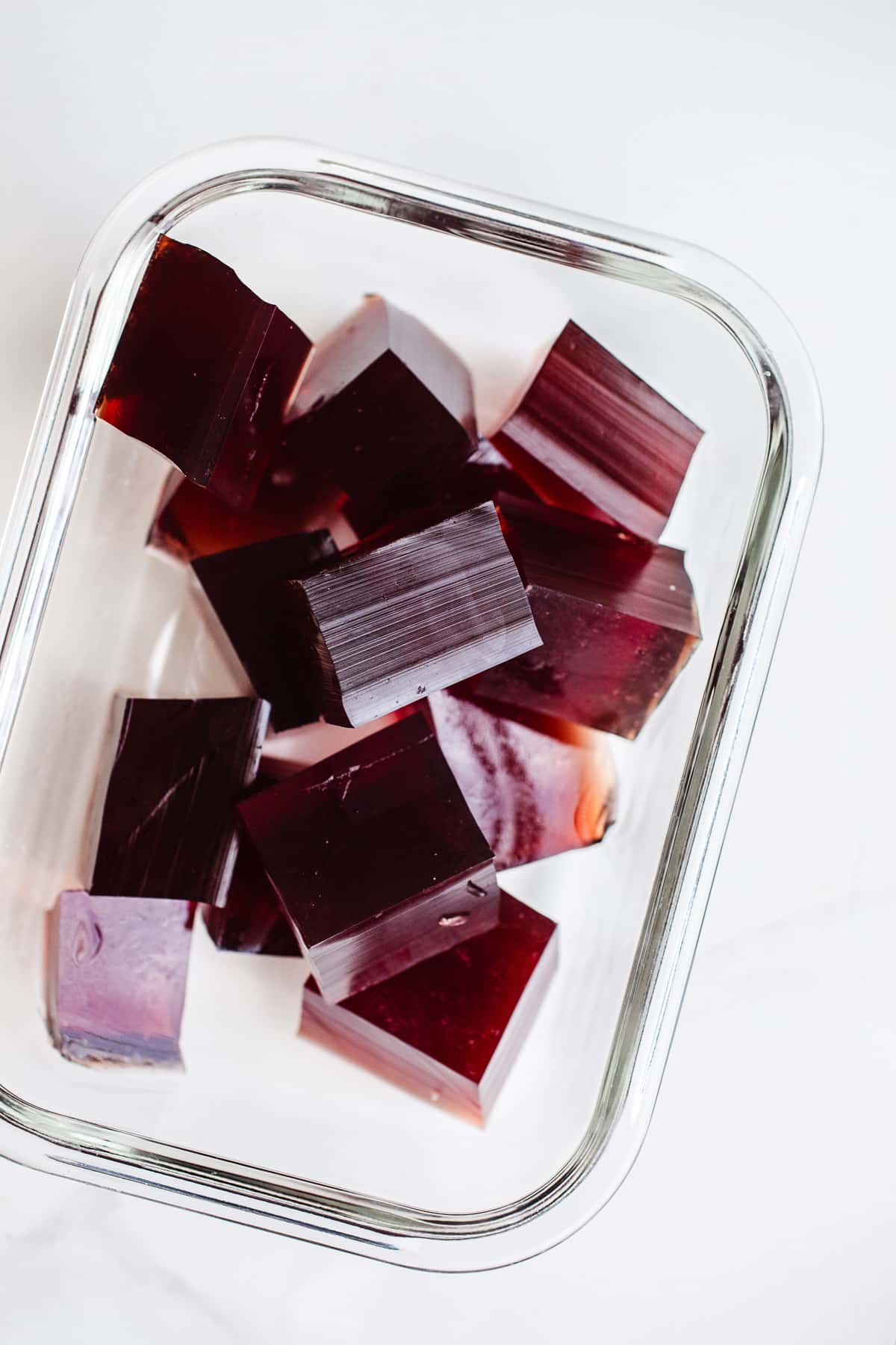 Blueberry gummies in a glass container.
