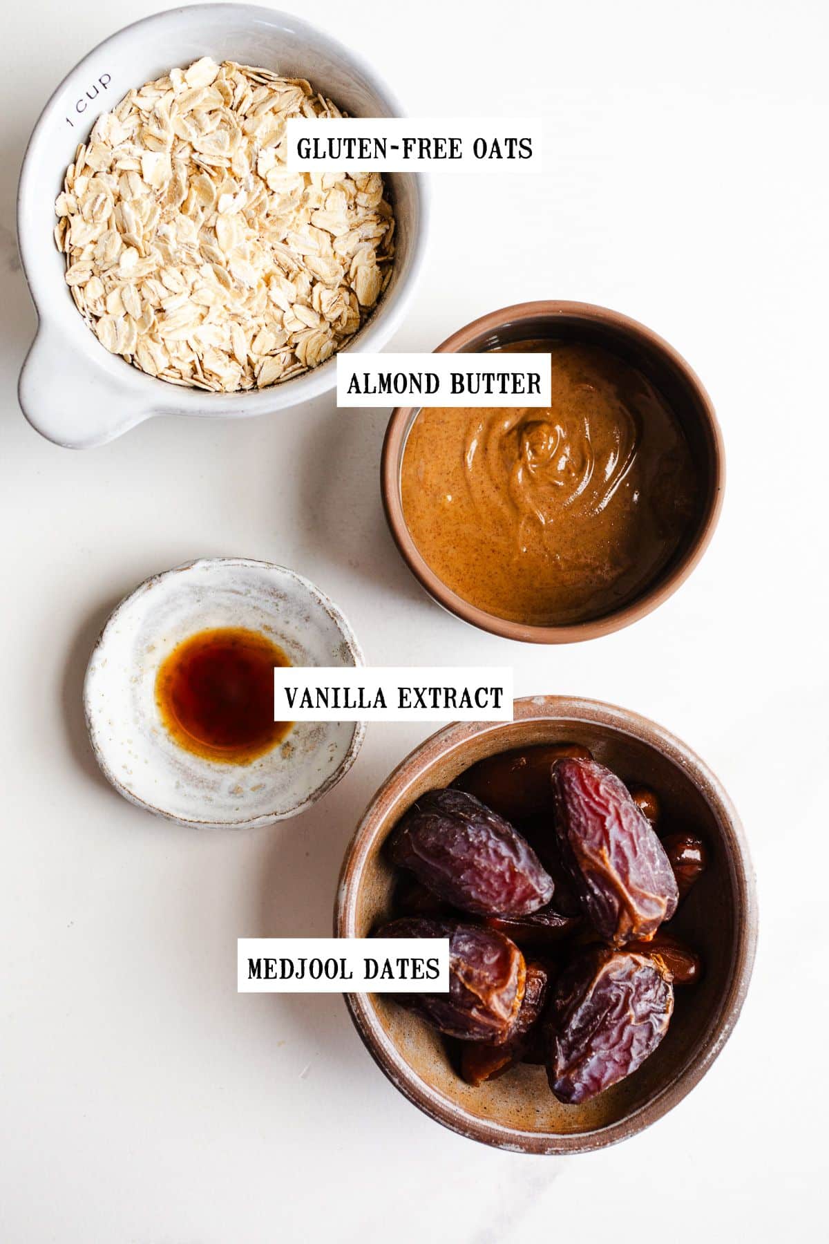 Ingredients to make bliss balls in small bowls. 