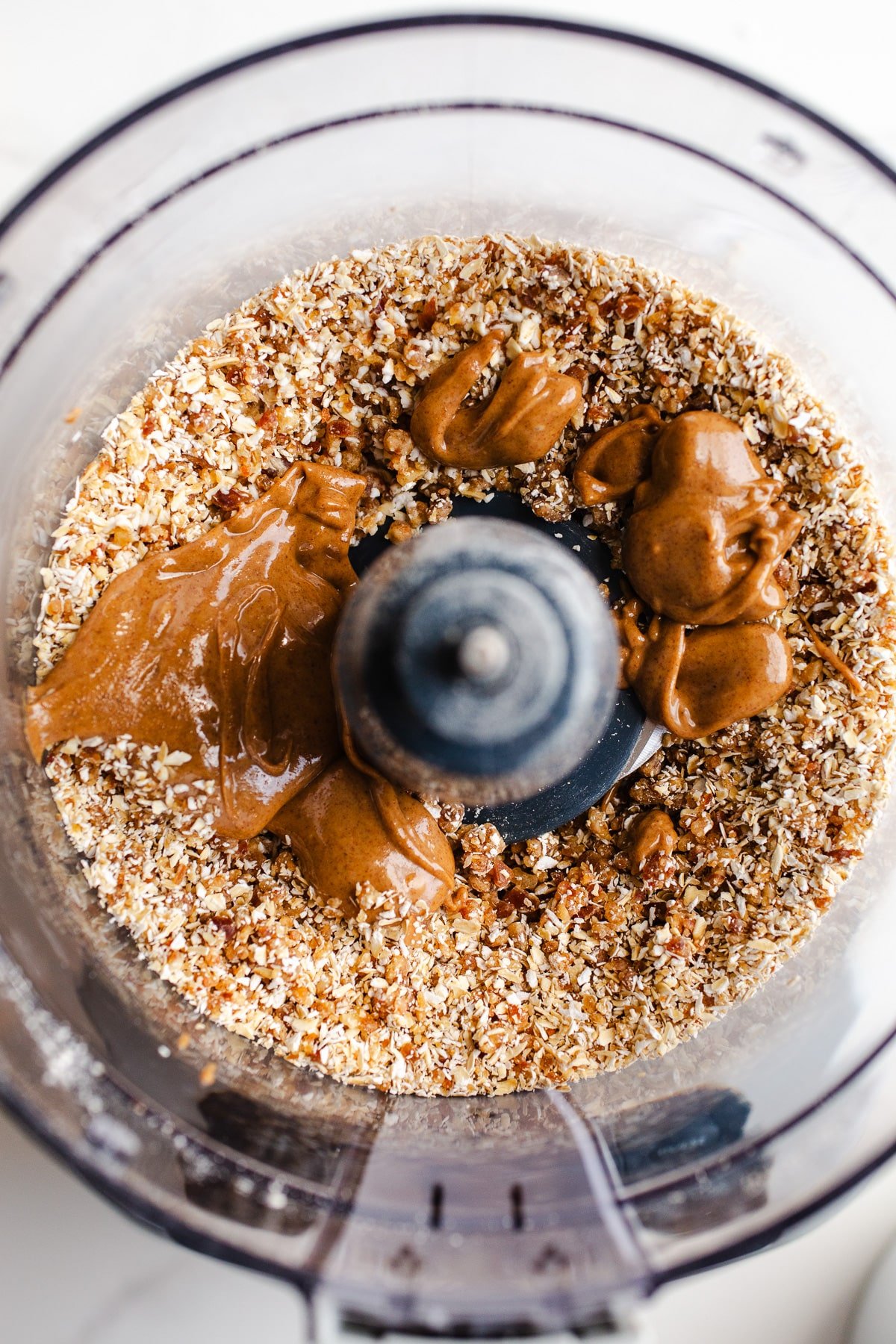 Almond butter and nuts in a food processor.
