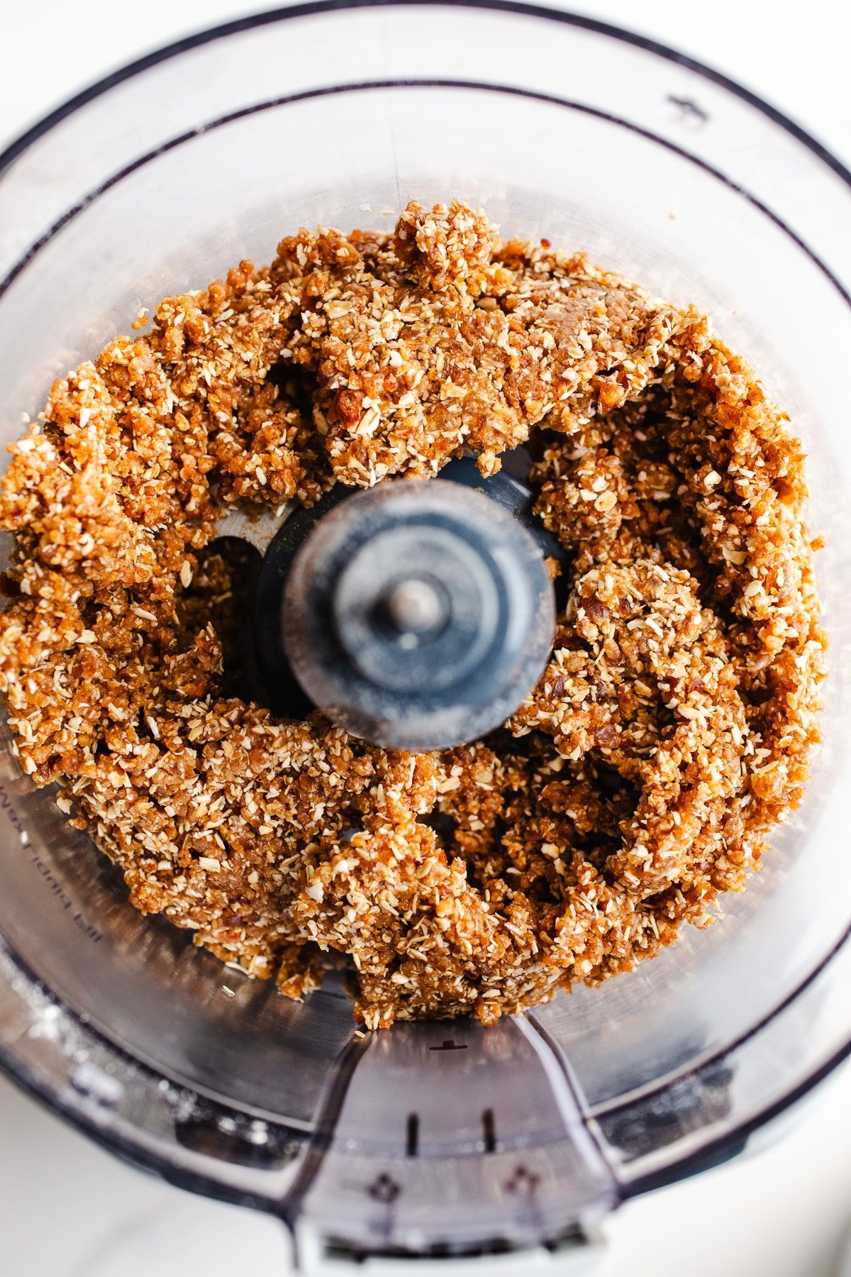 Dates, nuts, and almond butter in a food processor.