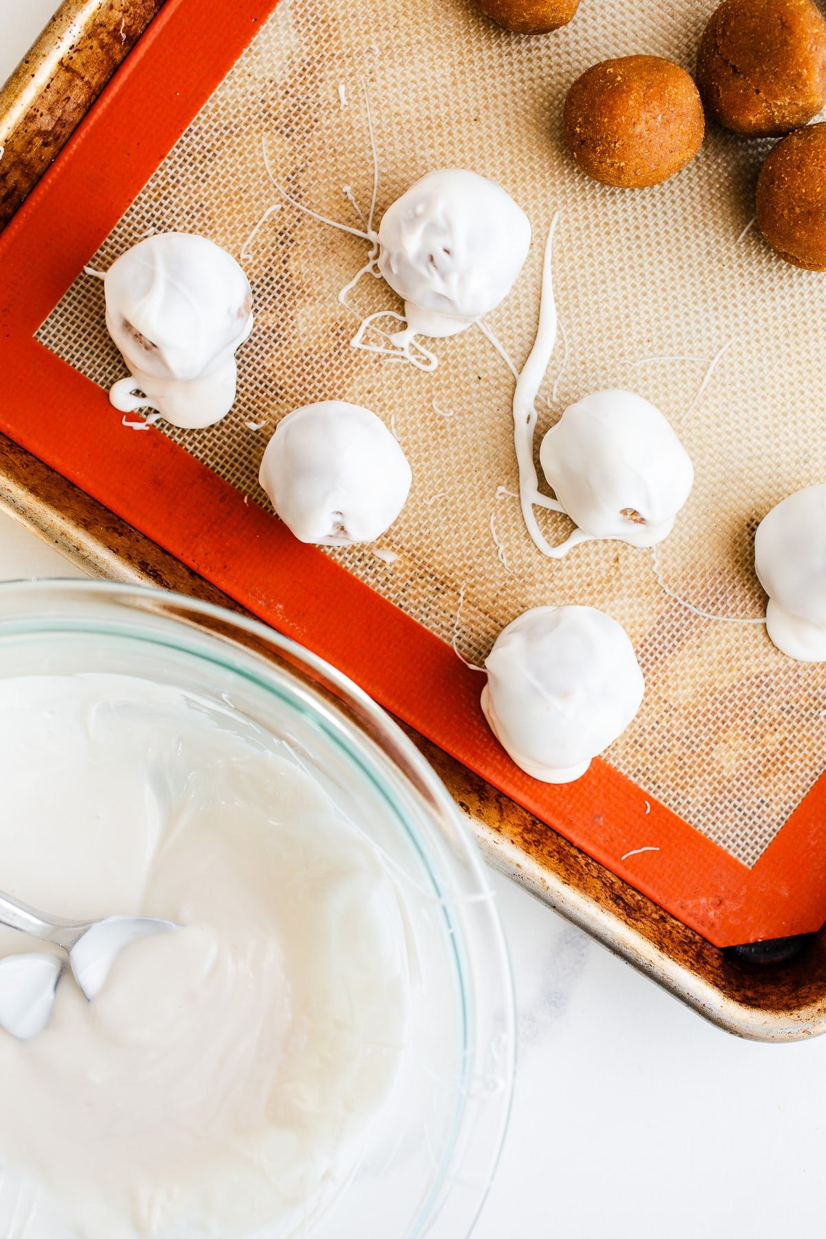 Pumpkin balls dipped in white chocolate. 