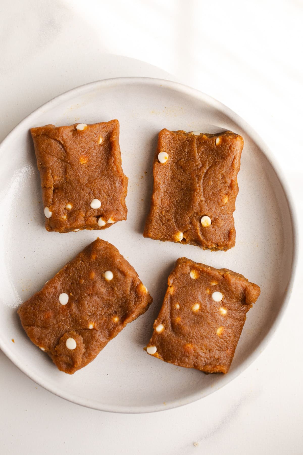 Square pumpkin protein bars on a plate. 