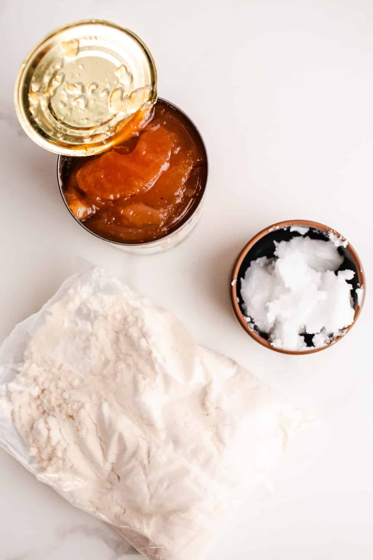 Ingredients to make apple dump cake on a marble surface.