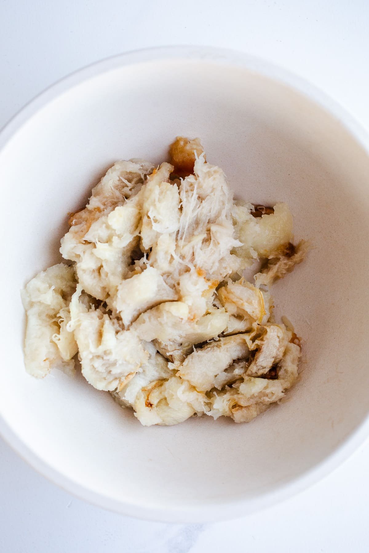 Roasted white squash in a mixing bowl.