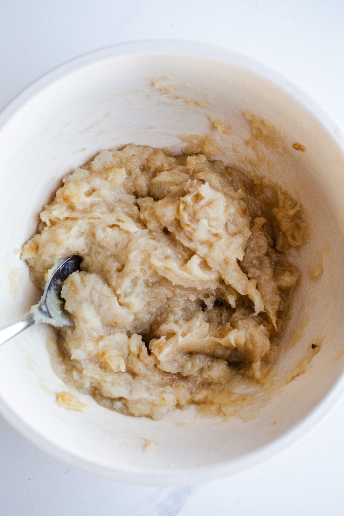 Creamy mashed squash in a mixing bowl.
